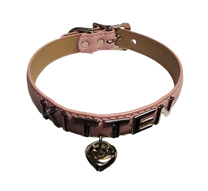 Pink faux leather collar with KITTEN letter studs and hanging bell top view