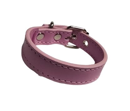 Pink faux leather cuff bracelet with buckle and eyelets front view