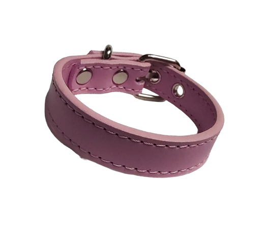 Pink faux leather cuff bracelet with buckle and eyelets front view