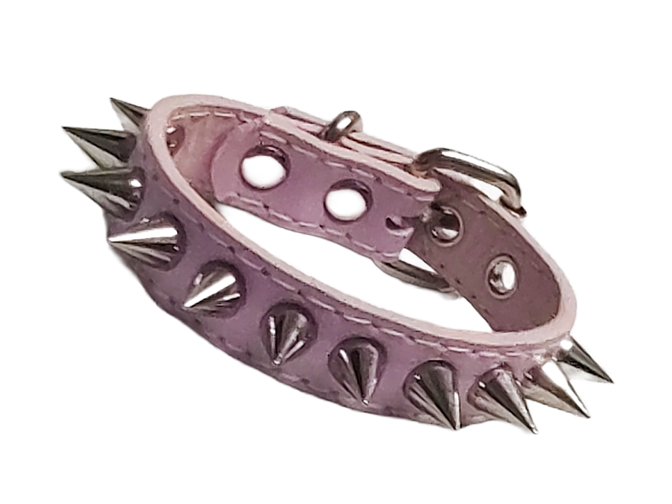 Light pink faux leather cuff bracelet with single row of cone spikes front view