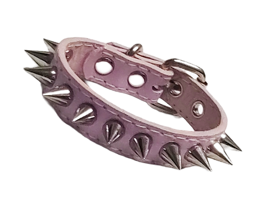 Light pink faux leather cuff bracelet with single row of cone spikes front view