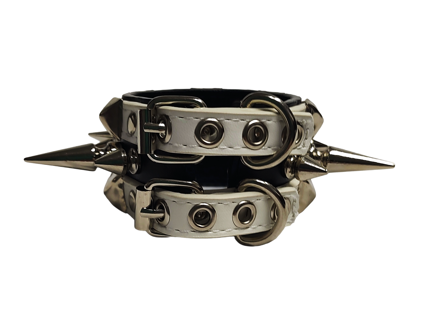 White and black faux leather cuff with alternating spikes and pyramid studs back view