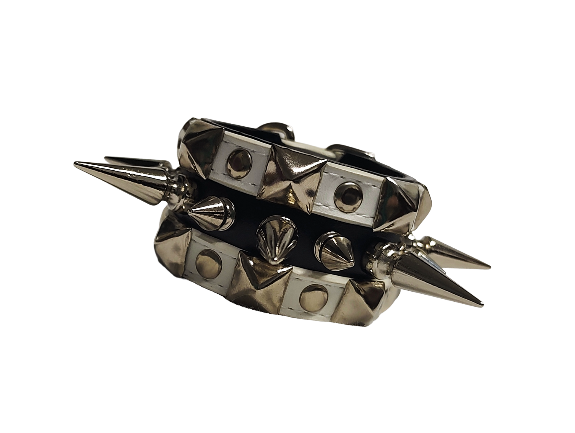 White and black faux leather cuff with alternating spikes and pyramid studs front flat view
