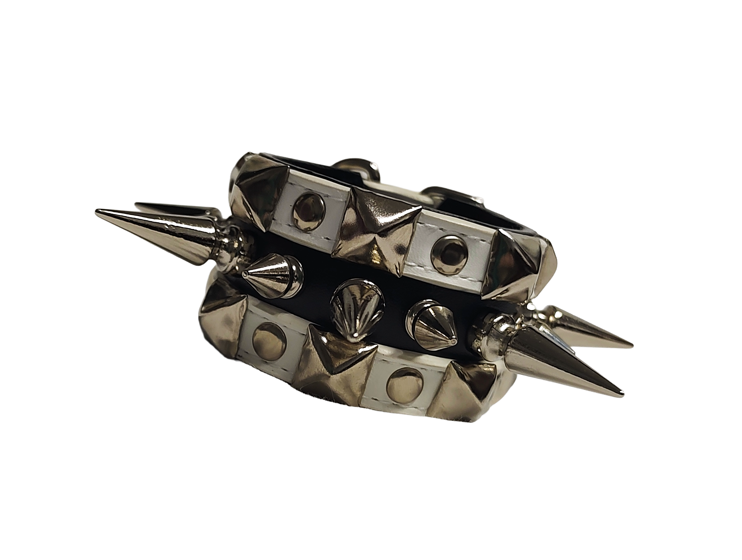 White and black faux leather cuff with alternating spikes and pyramid studs front flat view