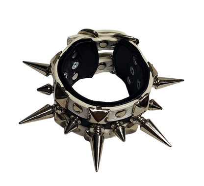 White and black faux leather cuff with alternating spikes and pyramid studs top front view