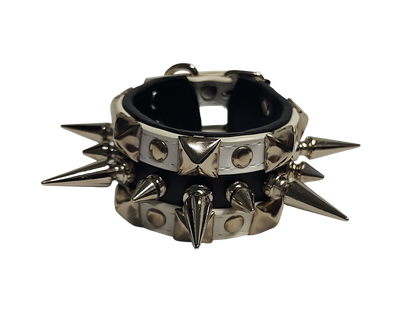 White and black faux leather cuff with alternating spikes and pyramid studs front view