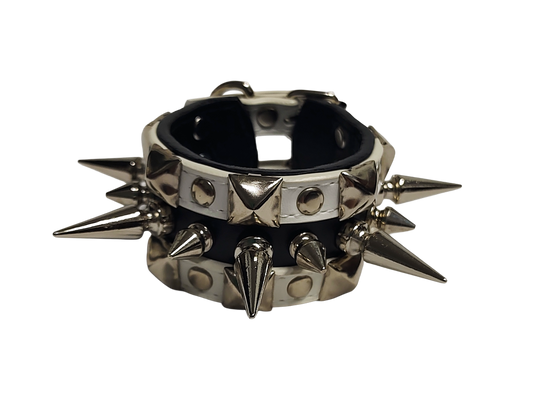 White and black faux leather cuff with alternating spikes and pyramid studs front view
