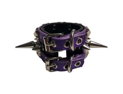 Purple and black faux leather cuff bracelet with alternating tree spikes rivets and pyramid studs back view
