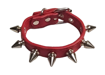 Red faux leather cuff with single row of spikes top view