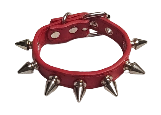 Red faux leather cuff with single row of spikes top view